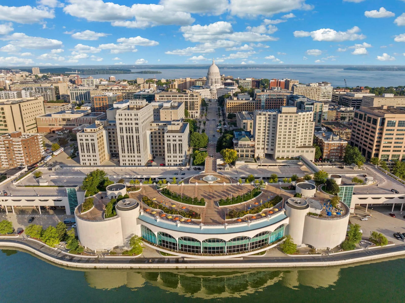 Aerial view of downtown Madison, Wisconsin with the Wisconsin State Capitol and Monona Terrace overlooking Lake Monona.